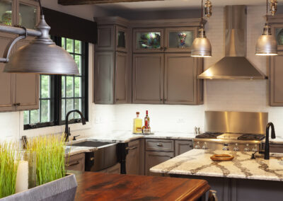 gray painted cabinetry with wood tone countertop kitchen island